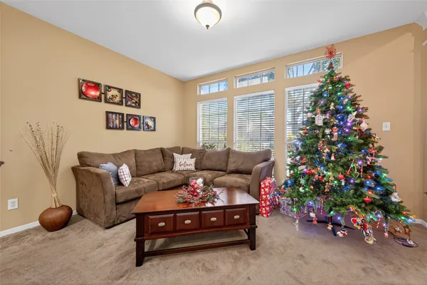 a living room with furniture and flowers