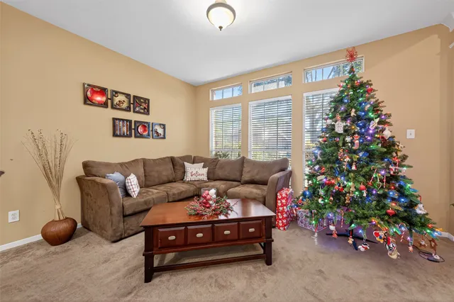 a living room with furniture and flowers