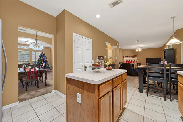 a kitchen with a sink a counter top space and dining table