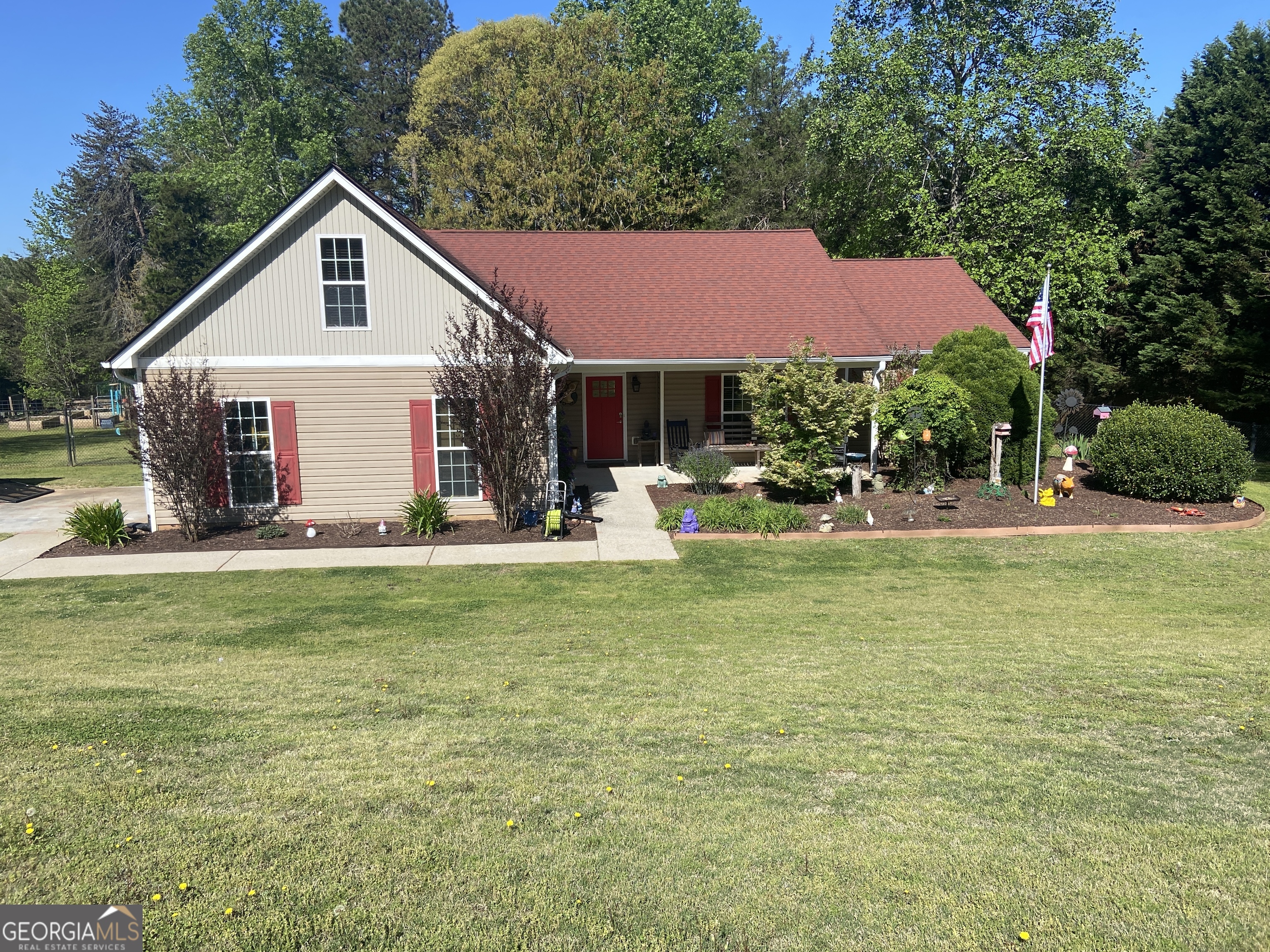 a front view of house with yard and trees
