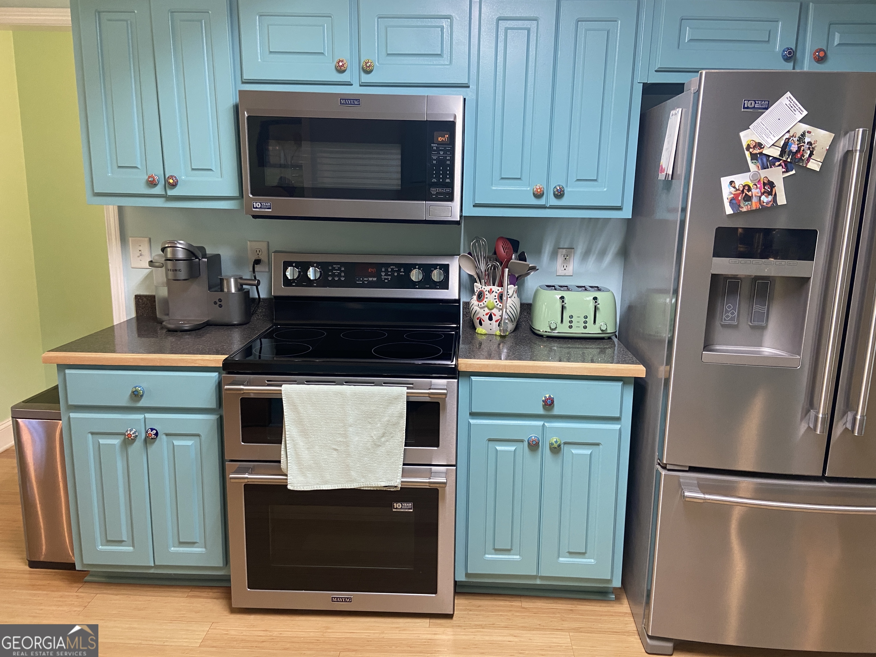 879 Hawk Creek Trail Winder, GA 30680 - Photo 13 of 30 a kitchen with stainless steel appliances granite countertop a stove and a refrigerator with cabinets