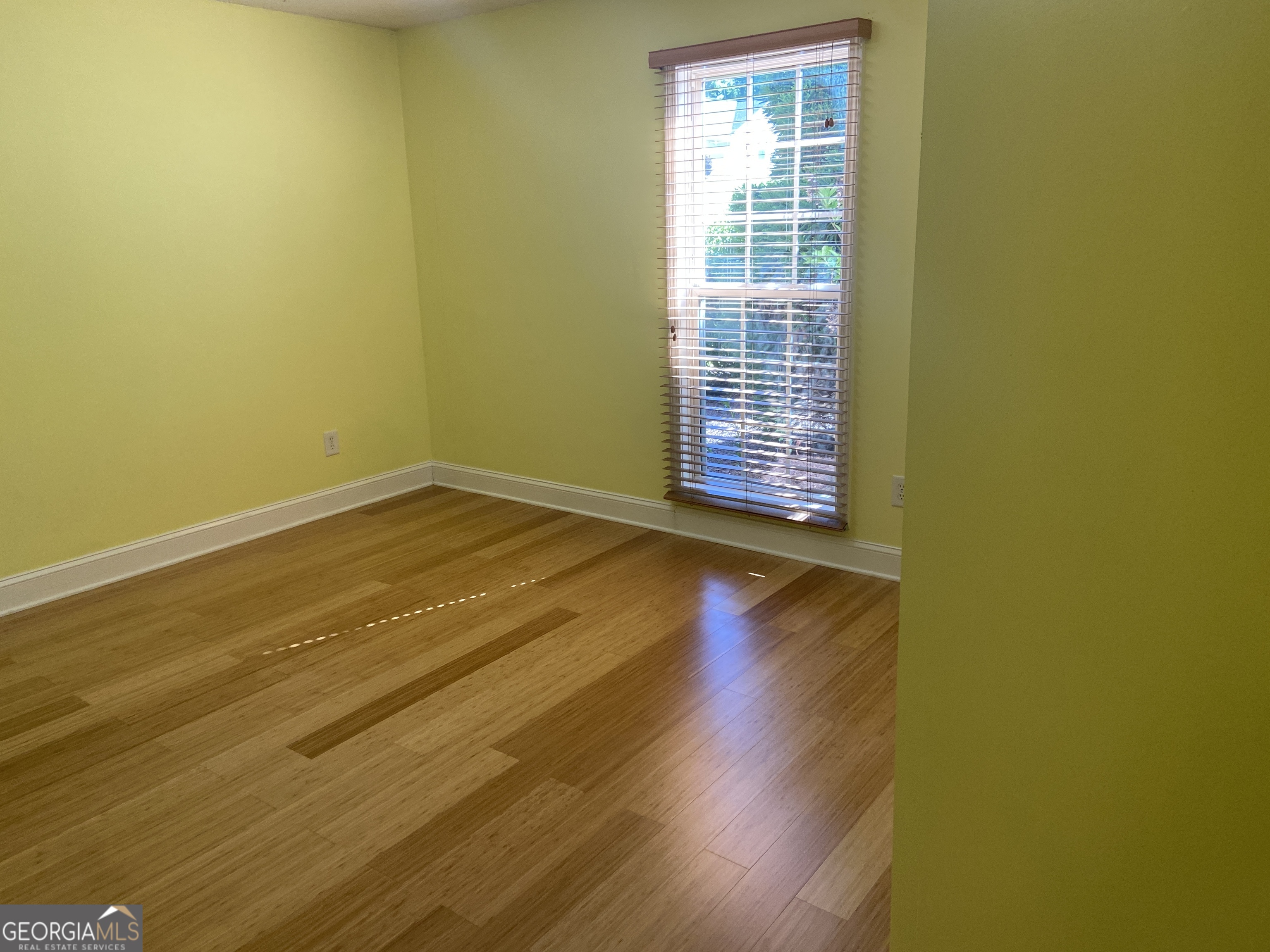 879 Hawk Creek Trail Winder, GA 30680 - Photo 20 of 30 a view of an empty room with wooden floor and a window