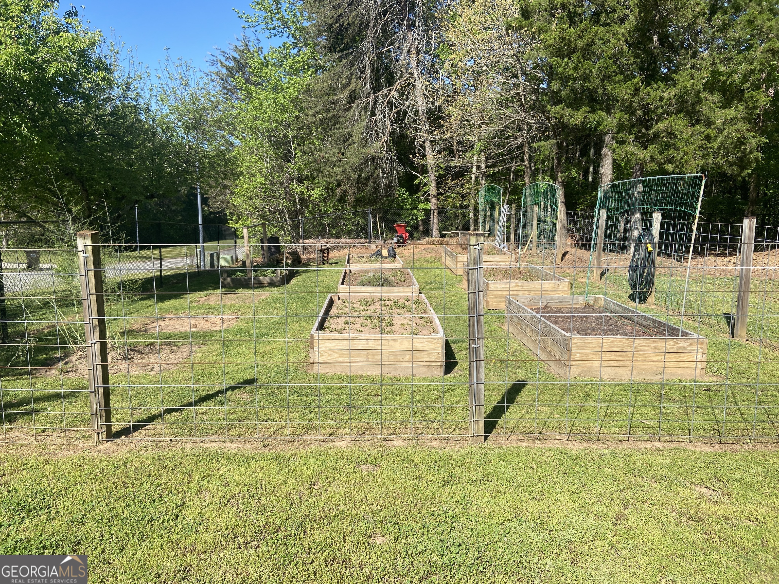879 Hawk Creek Trail Winder, GA 30680 - Photo 26 of 30 a view of swimming pool with seating area and trees in the background