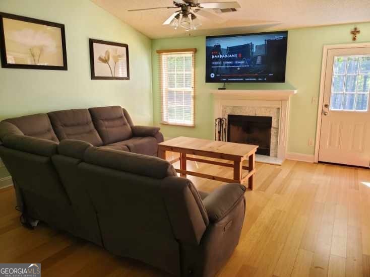 879 Hawk Creek Trail Winder, GA 30680 - Photo 7 of 30 a living room with furniture a flat screen tv and a fireplace