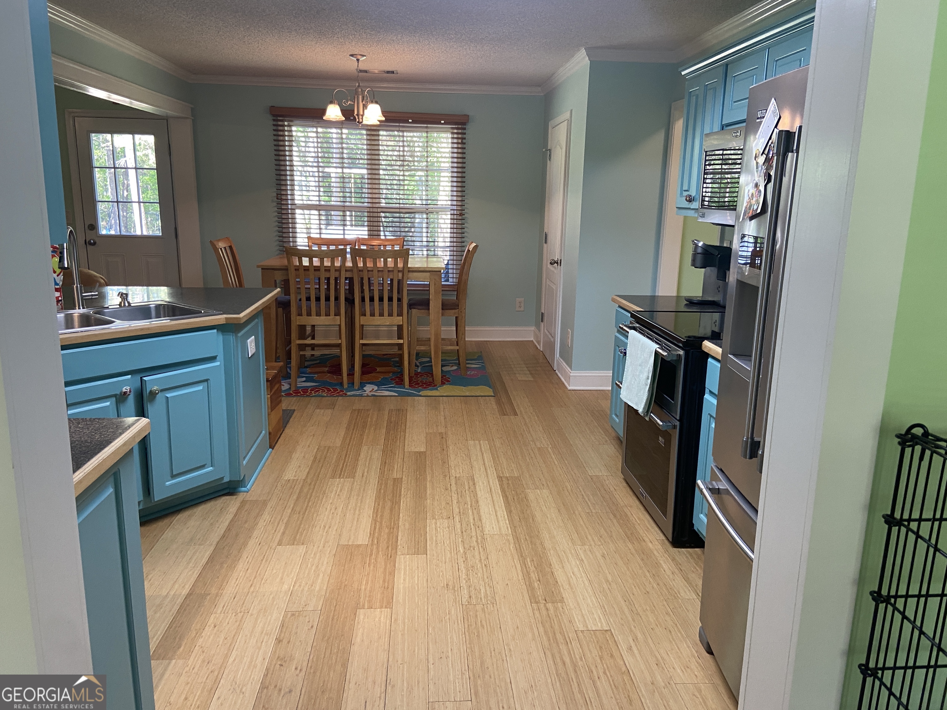 879 Hawk Creek Trail Winder, GA 30680 - Photo 10 of 30 a dining room with stainless steel appliances furniture a window and wooden floor