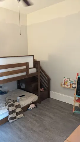 a bedroom with a bed and a lamp on table