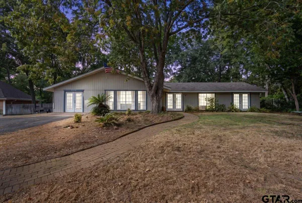 a view of house with outdoor space and yard