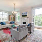 a living room with furniture fireplace and a table