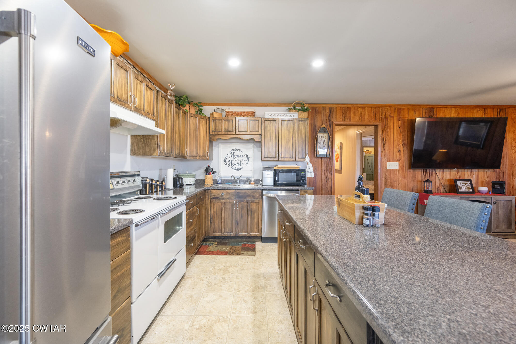 982 Lost Creek Boat Dock Road Decaturville, TN 38329 - Photo 14 of 31 a kitchen with stainless steel appliances granite countertop a sink stove and refrigerator