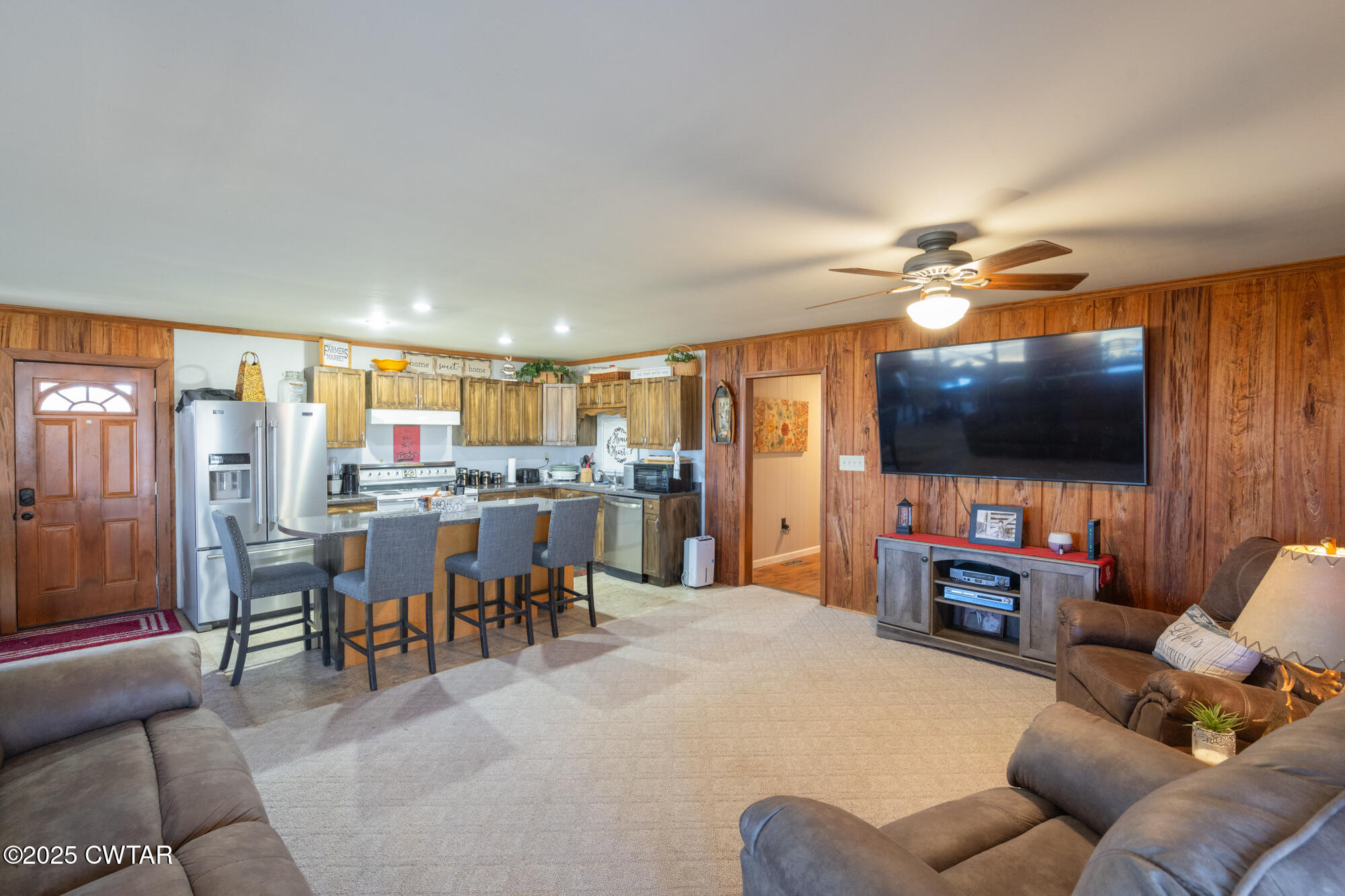 982 Lost Creek Boat Dock Road Decaturville, TN 38329 - Photo 10 of 31 a living room with furniture and a flat screen tv