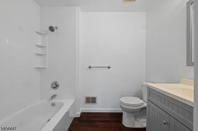 a bathroom with a toilet and a bath tub