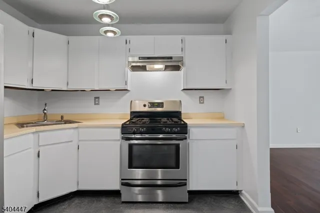 a kitchen with cabinets appliances and a sink