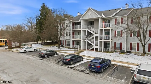 a car parked in front of a white house