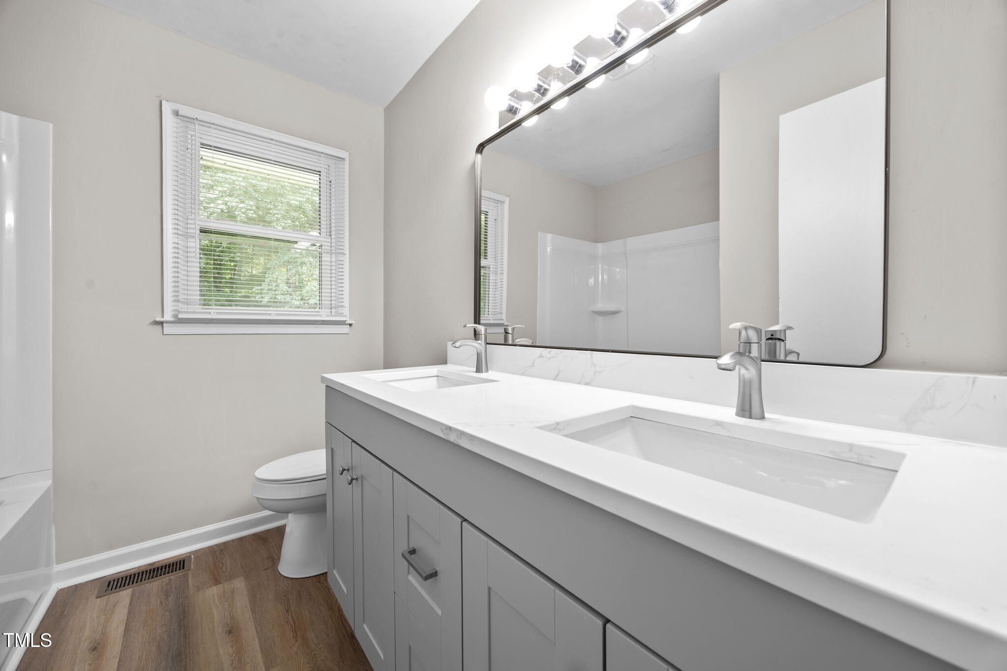 1050 Rock Spring Church Road Henderson, NC 27537 - Photo 11 of 24 a bathroom with a granite countertop sink a toilet and a mirror