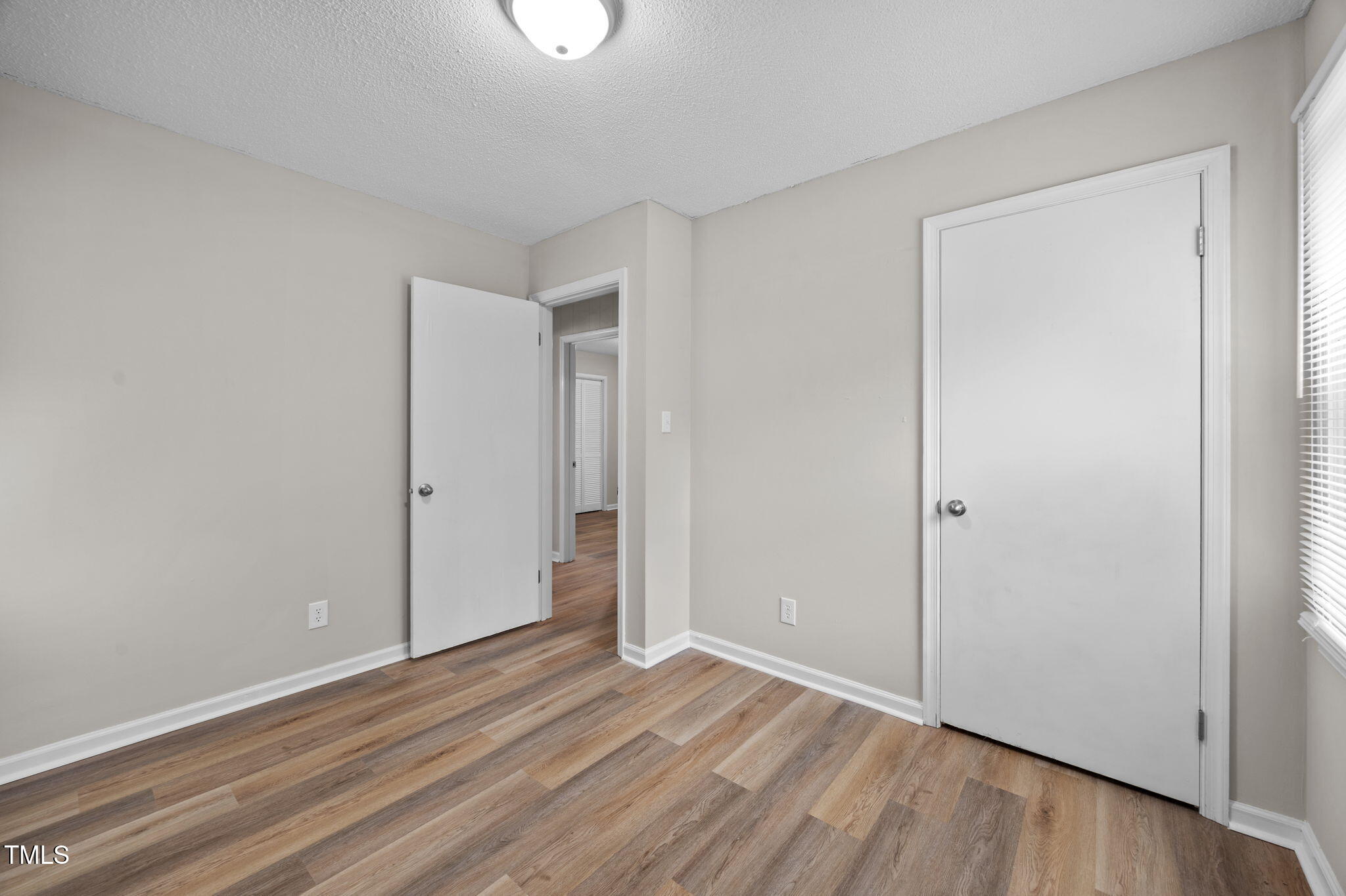 1050 Rock Spring Church Road Henderson, NC 27537 - Photo 13 of 24 a view of an empty room and wooden floor