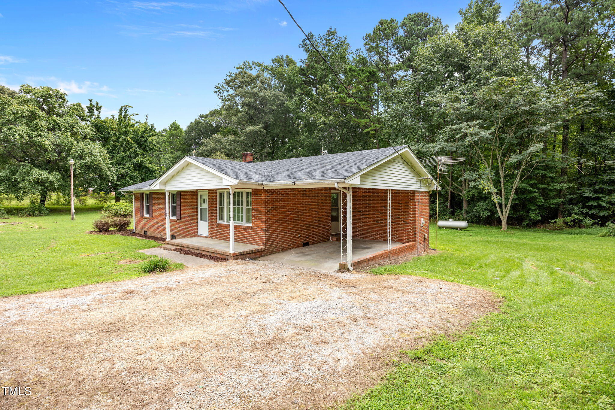 1050 Rock Spring Church Road Henderson, NC 27537 - Photo 17 of 24 a view of house with wooden fence and trees in the background