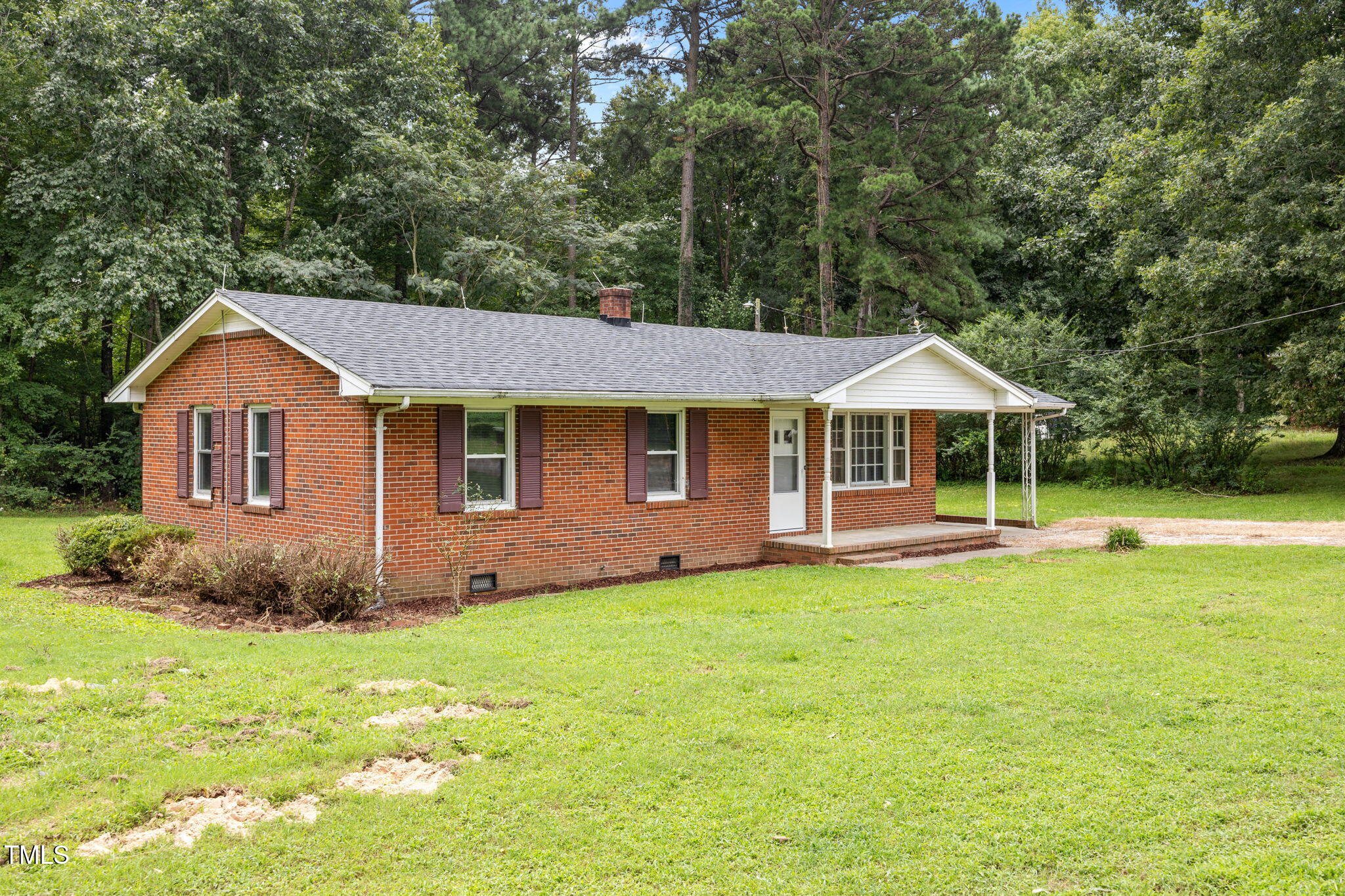 1050 Rock Spring Church Road Henderson, NC 27537 - Photo 18 of 24 a front view of a house with garden