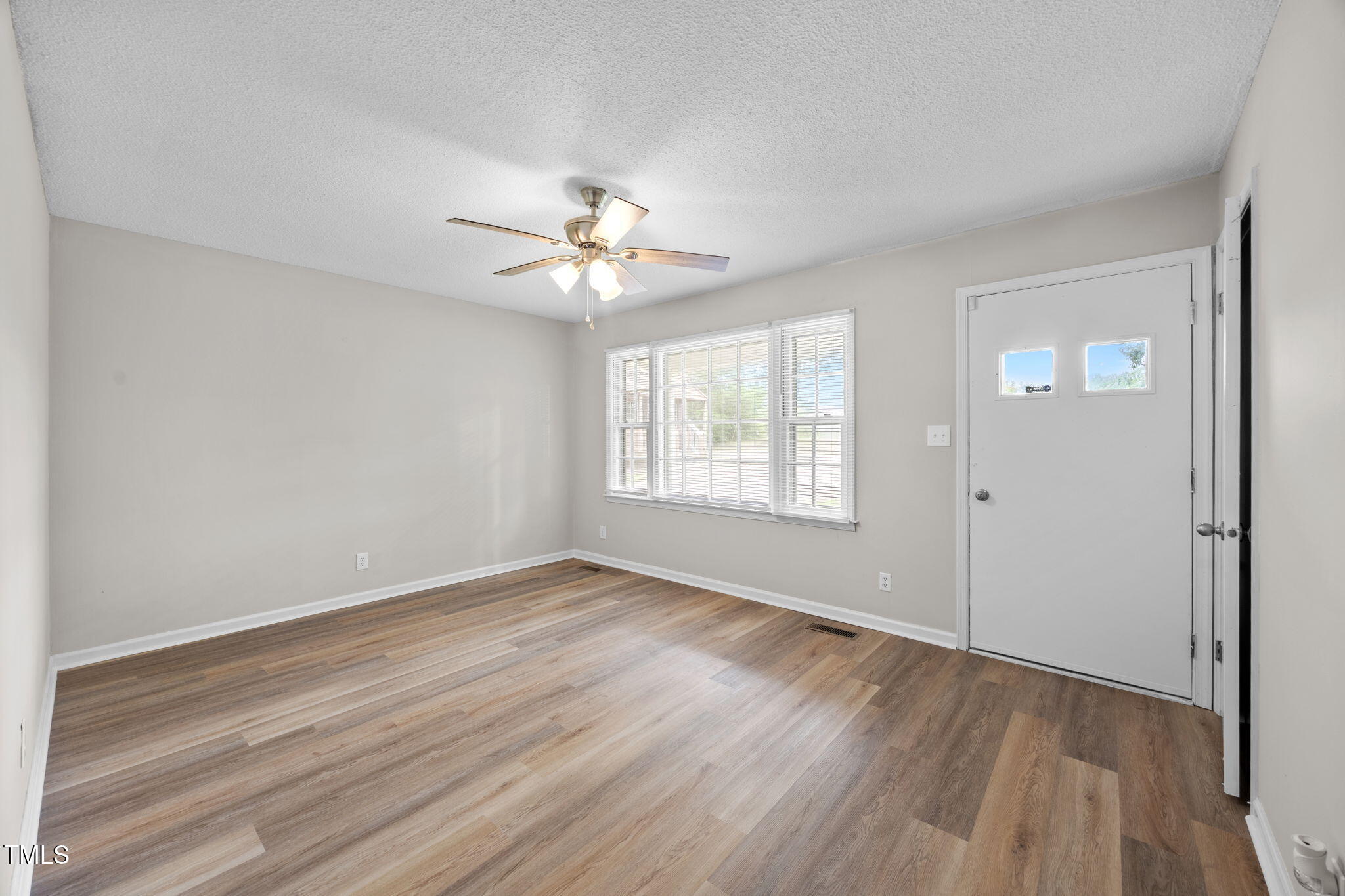 1050 Rock Spring Church Road Henderson, NC 27537 - Photo 2 of 24 wooden floor in an empty room with a window