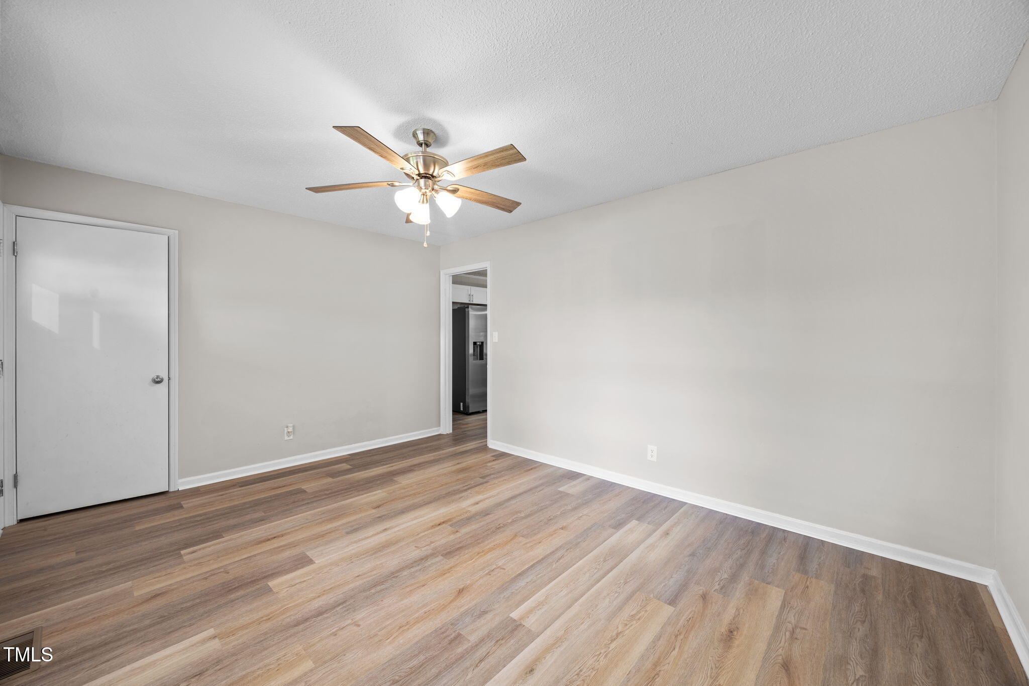 1050 Rock Spring Church Road Henderson, NC 27537 - Photo 3 of 24 a view of an empty room with a fan