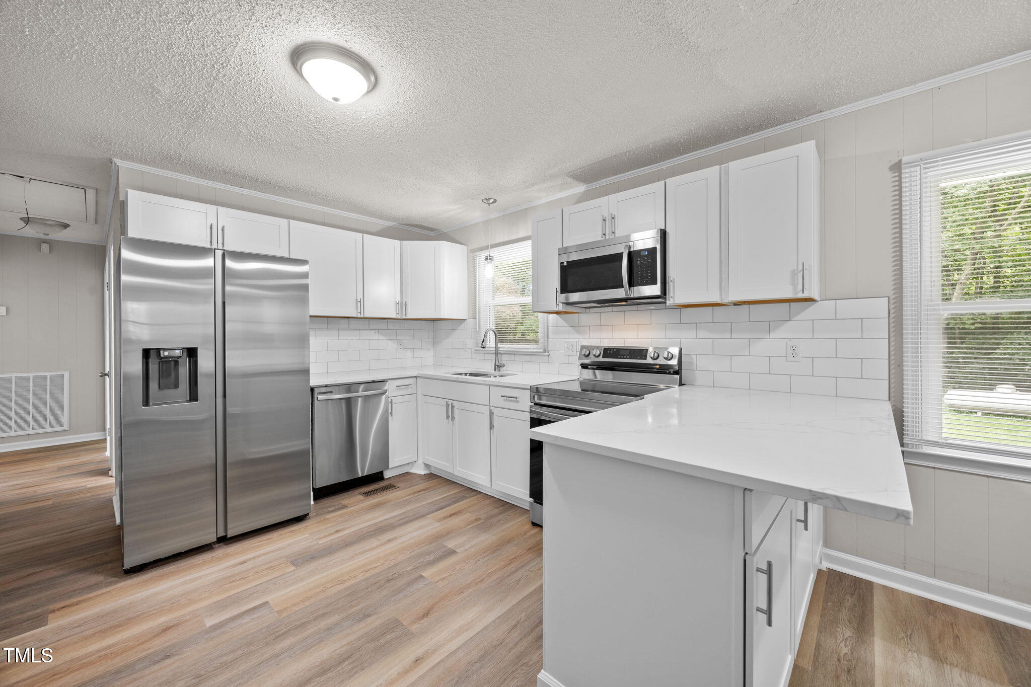 1050 Rock Spring Church Road Henderson, NC 27537 - Photo 6 of 24 a kitchen with a refrigerator sink and microwave