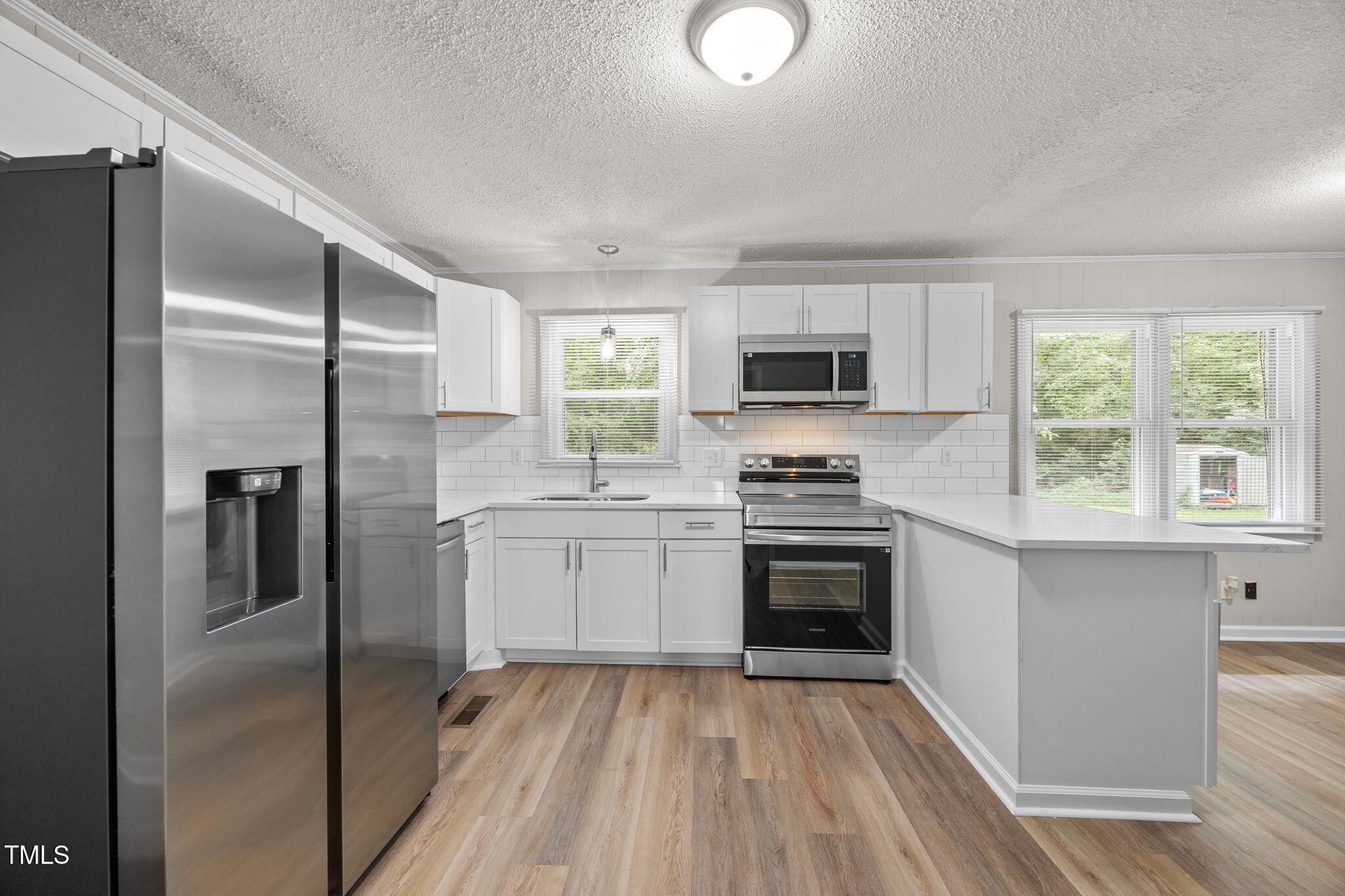 1050 Rock Spring Church Road Henderson, NC 27537 - Photo 7 of 24 a kitchen with a refrigerator stove and microwave