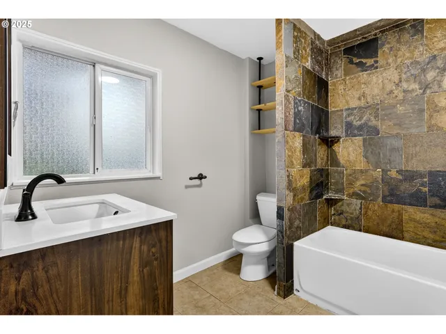 a bathroom with a sink toilet a mirror and shower