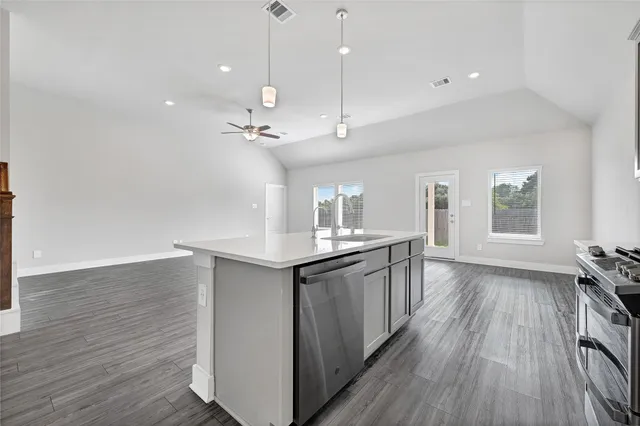 a view of a kitchen with a sink and wooden floor
