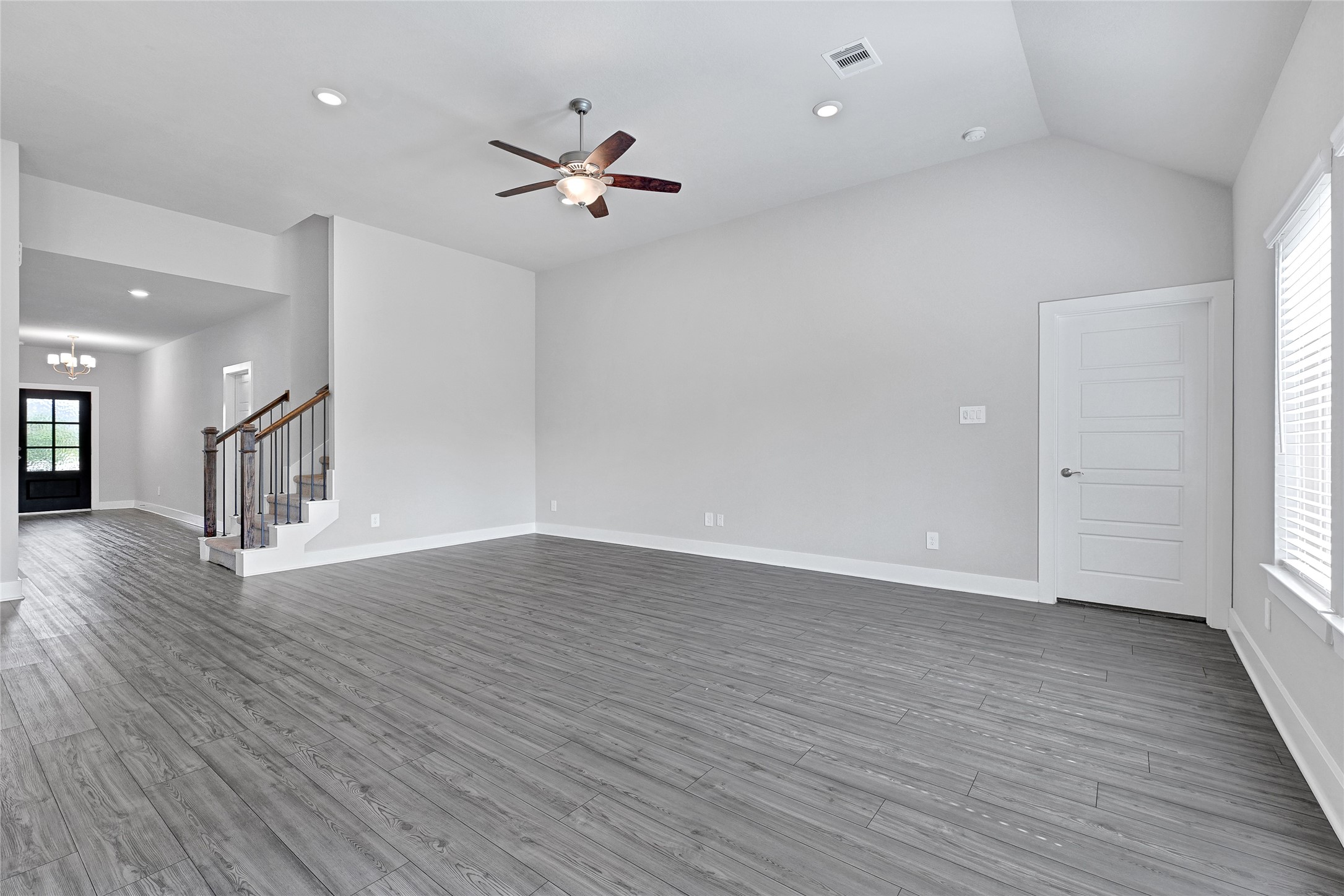 10329 South Goshawk Trail Conroe, TX 77385 - Photo 16 of 46 a view of an empty room with wooden floor and a window