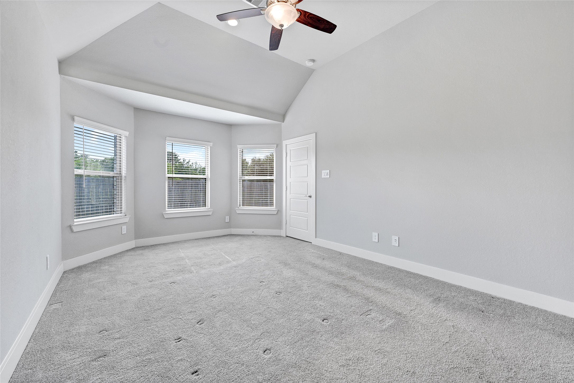 10329 South Goshawk Trail Conroe, TX 77385 - Photo 18 of 46 an empty room with windows and ceiling fan