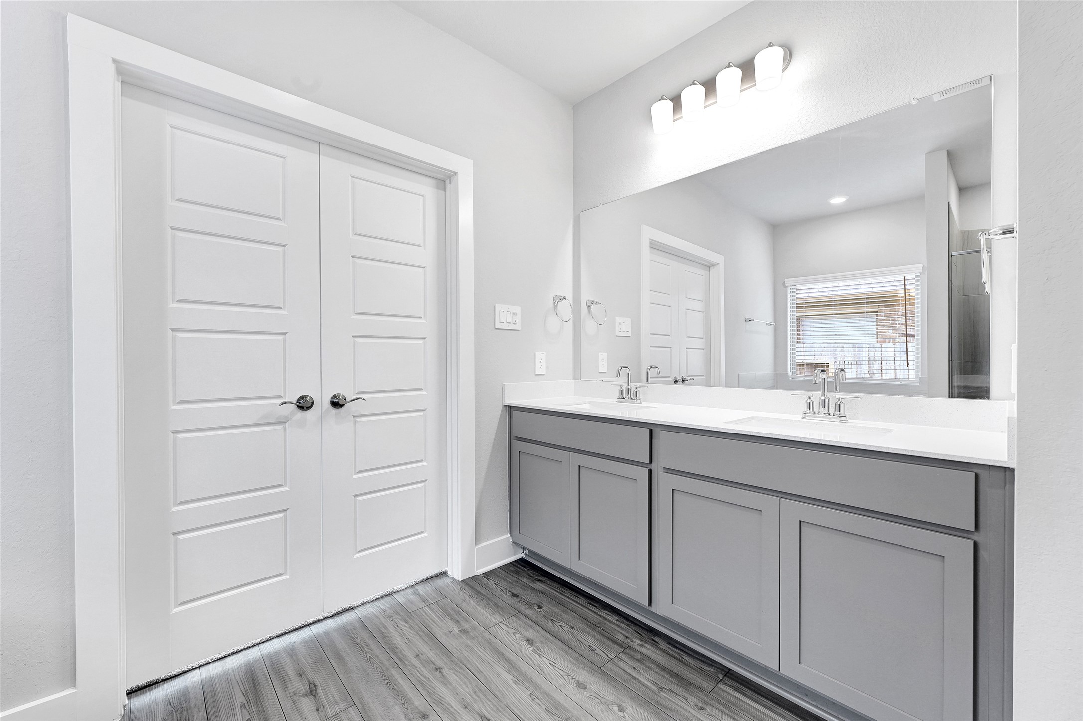 10329 South Goshawk Trail Conroe, TX 77385 - Photo 21 of 46 a spacious bathroom with a double vanity sink and mirror