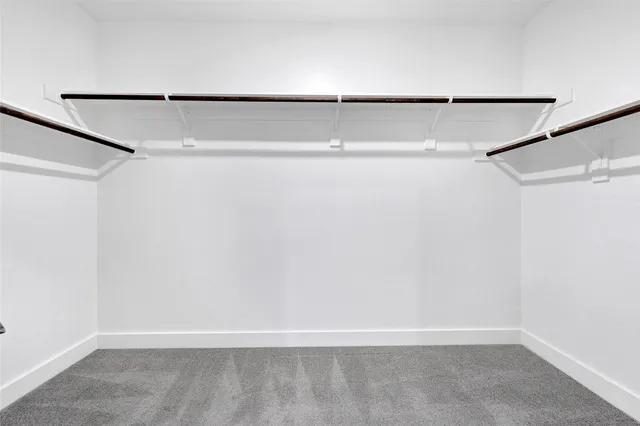 a spacious bathroom with a double vanity sink and mirror