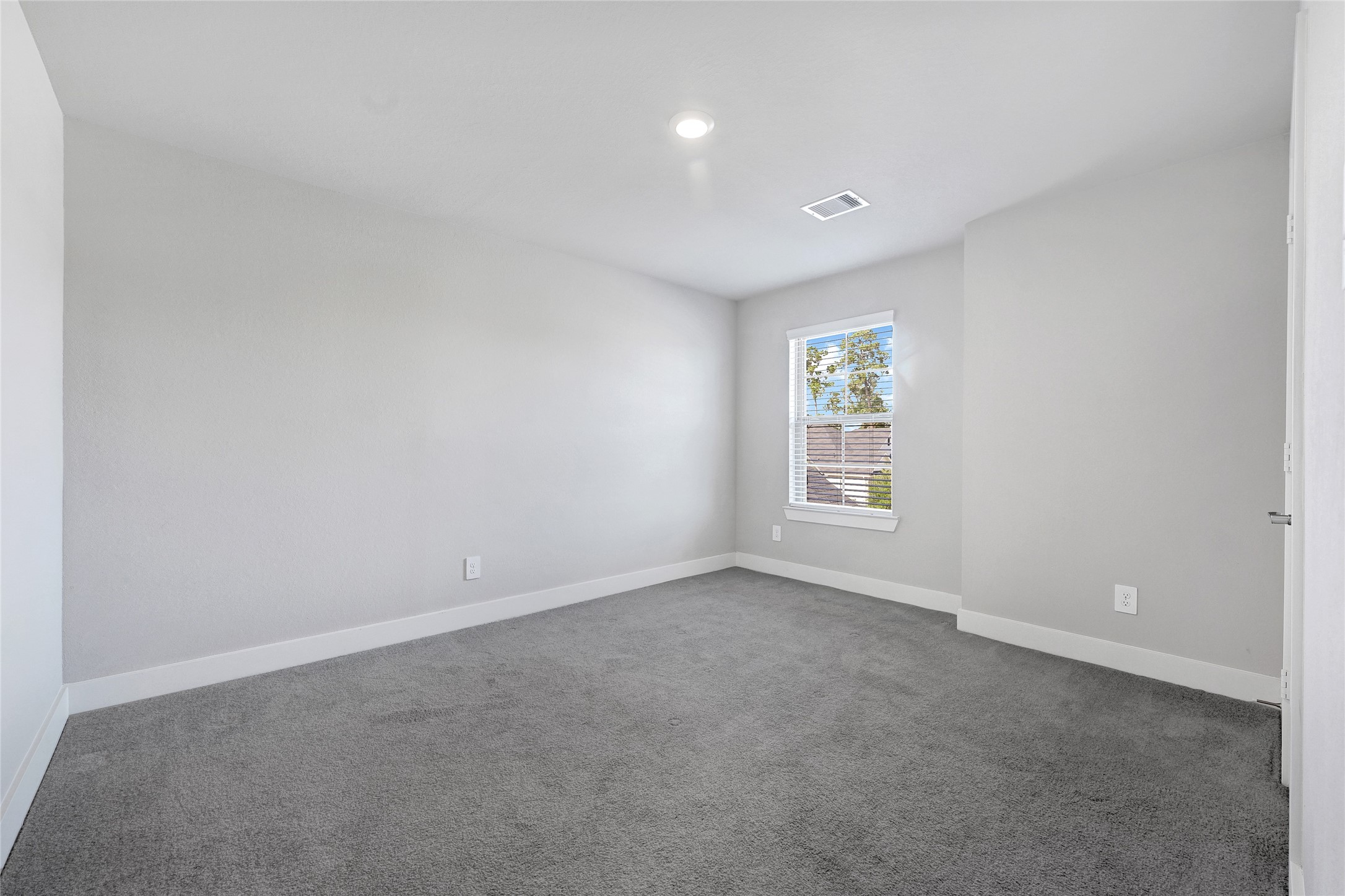10329 South Goshawk Trail Conroe, TX 77385 - Photo 30 of 46 a view of an empty room with a window