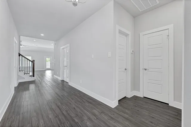 a view of an empty room with wooden floor