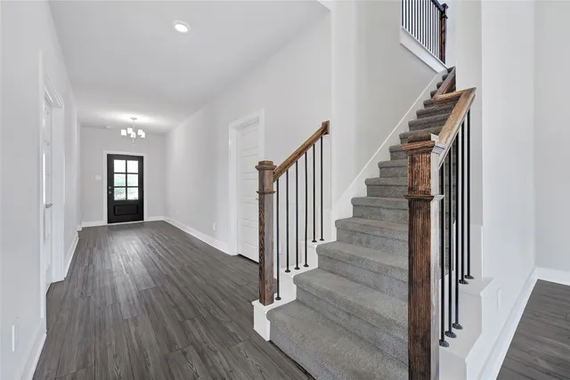 a view of entryway with wooden floor and stairs