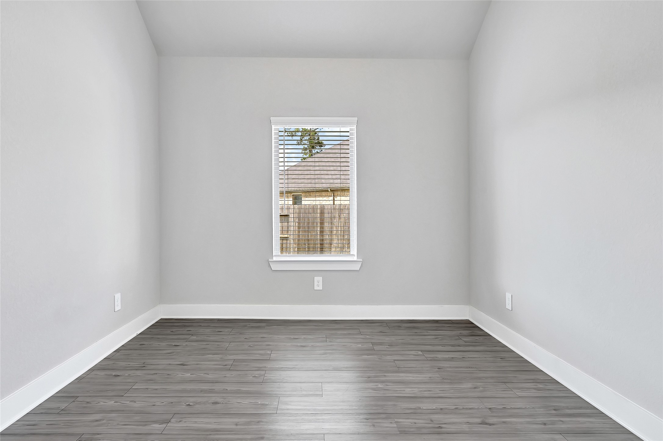 10329 South Goshawk Trail Conroe, TX 77385 - Photo 7 of 46 wooden floor in an empty room with a window