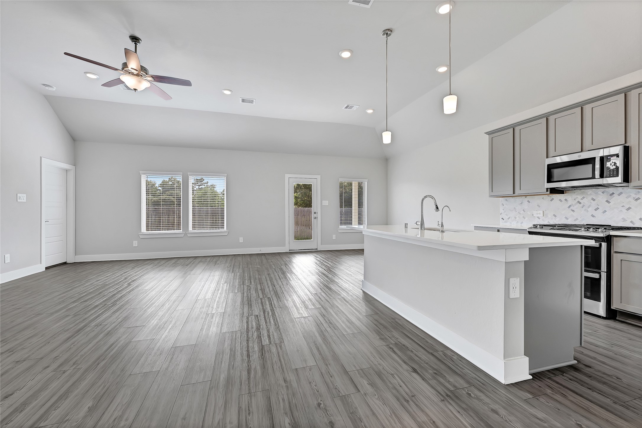 10329 South Goshawk Trail Conroe, TX 77385 - Photo 8 of 46 a kitchen with stainless steel appliances granite countertop a stove top oven a sink with wooden floors and cabinets