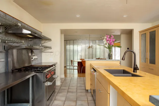 a kitchen with kitchen island a sink stove and refrigerator