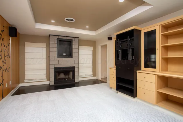 a living room with a fireplace and a potted plant