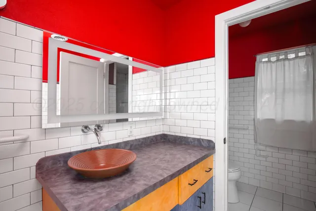 a blue swimming pool with red umbrella