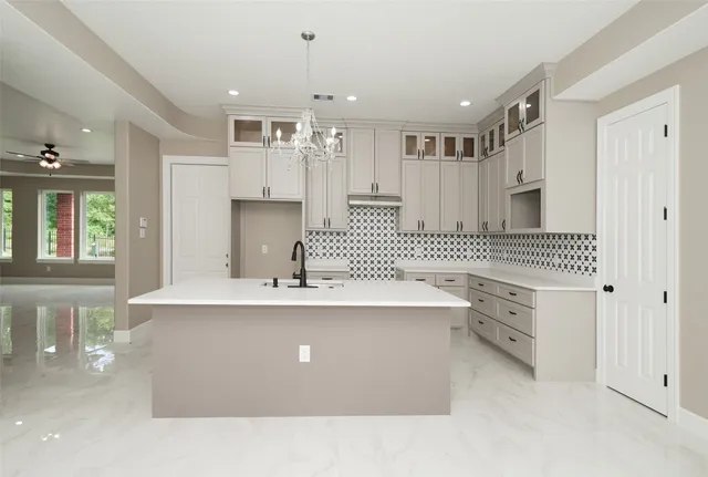 a kitchen with kitchen island a sink stainless steel appliances and cabinets