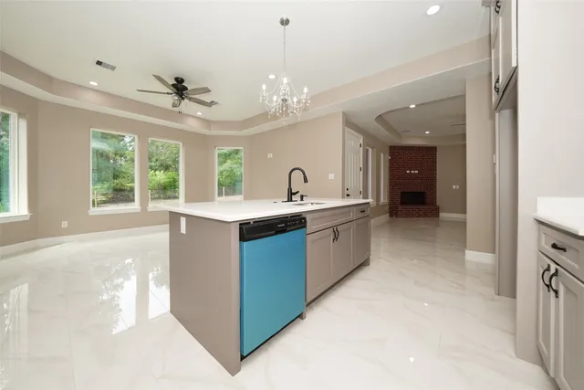 a kitchen with sink stove and cabinets