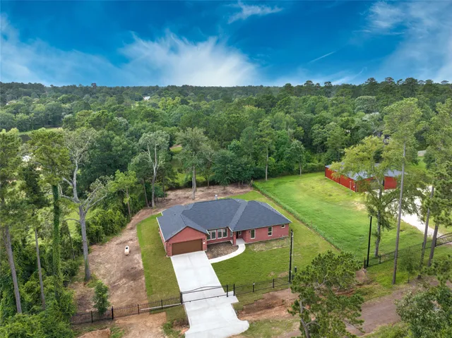 a front view of a house with a garden and yard