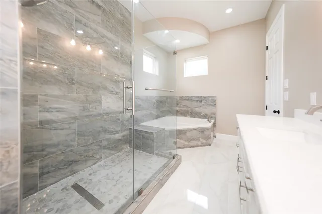 a bathroom with a granite countertop sink a mirror and a shower