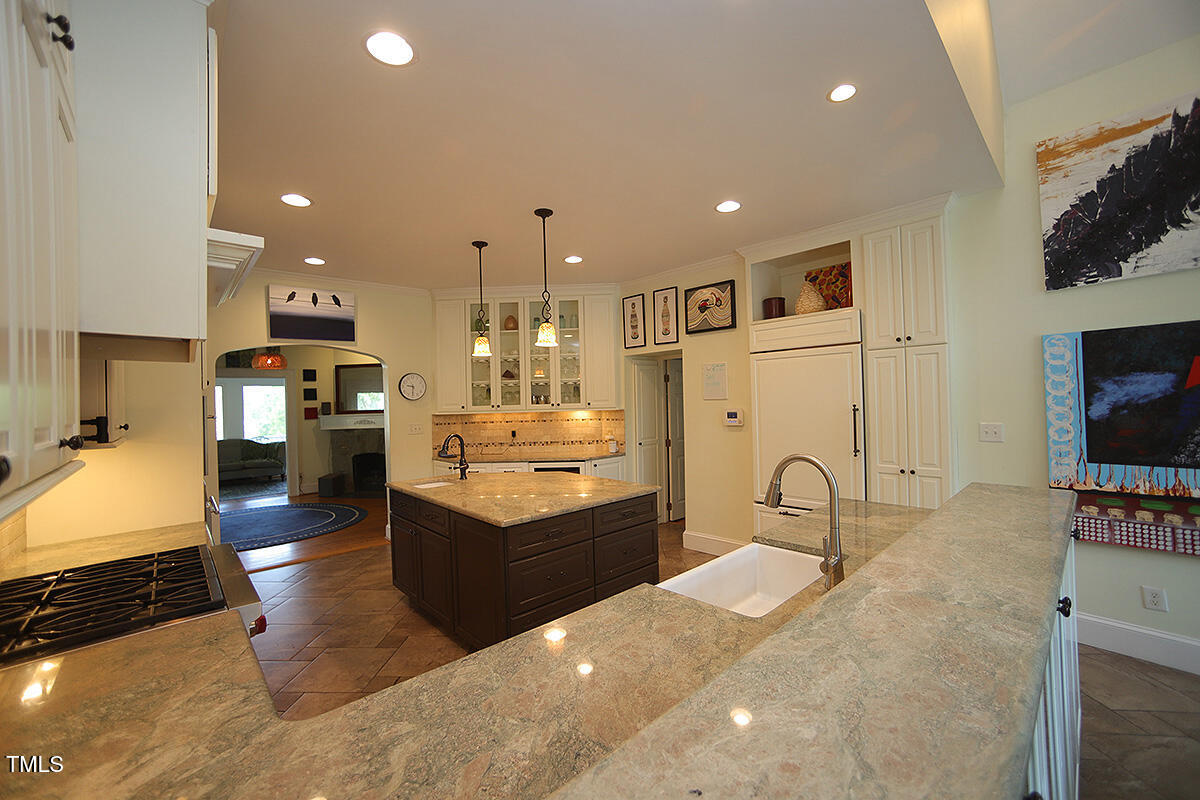3409 White Oak Road Raleigh, NC 27609 - Photo 9 of 24 a kitchen with stainless steel appliances kitchen island granite countertop a refrigerator and stove