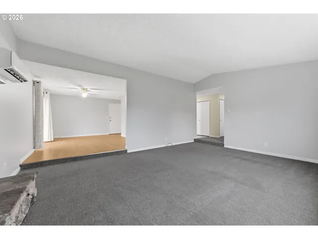 a view of an empty room and wooden floor