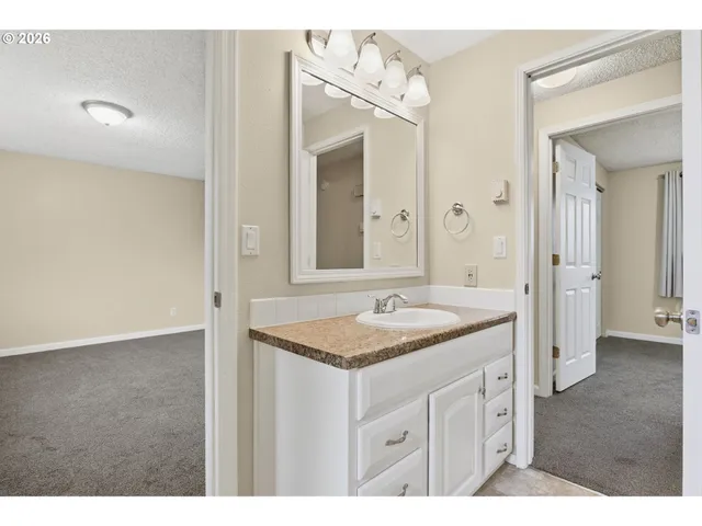 a bathroom with a granite countertop sink mirror and a
