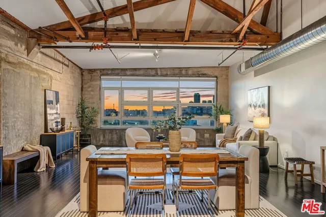 a view of a dining room with furniture a chandelier and wooden floor