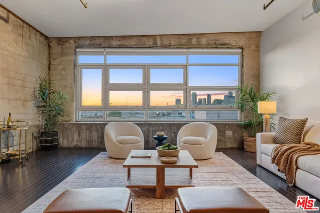 a living room with furniture a rug and a chandelier