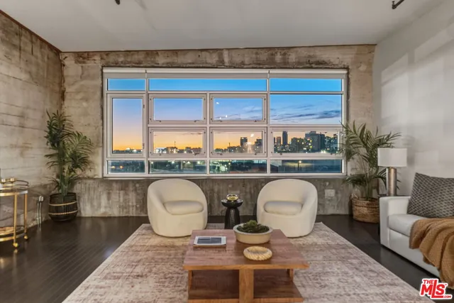 a view of a room with lots of furniture and wooden floor
