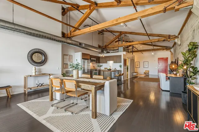 a living room with furniture a rug and white walls